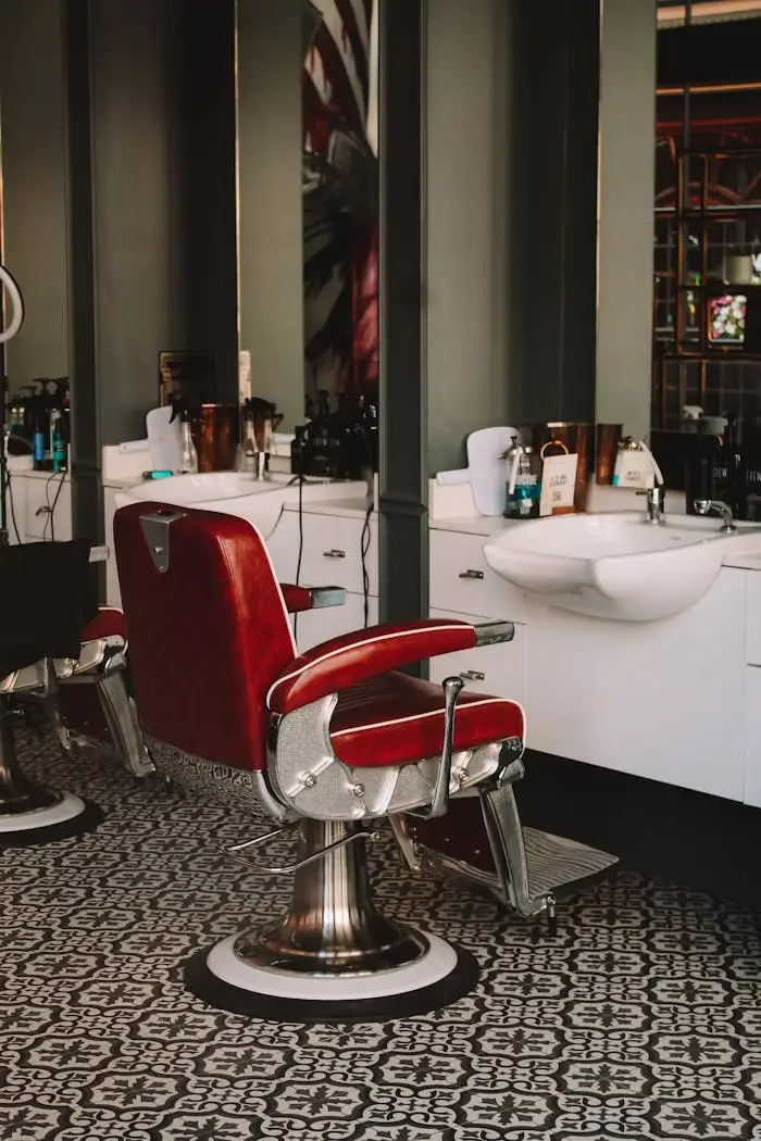 gallery-02 Stylish barbershop interior featuring iconic red leather chairs and modern decor.