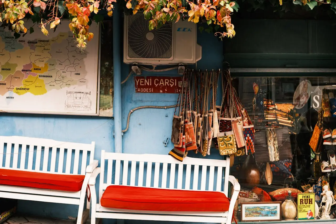 about-img-01 Vibrant outdoor market scene featuring decorative items, benches, and autumn leaves.